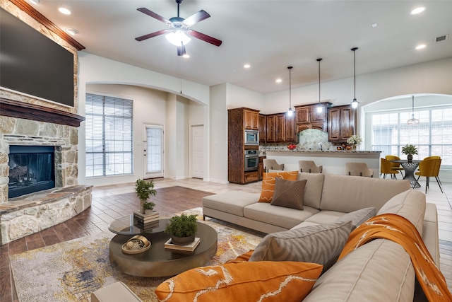 7611 Forest Ridge Trl, Sachse, TX 75048 - living area featuring ceiling fan, arched walkways, plenty of natural light, light wood-type flooring, and recessed lighting
