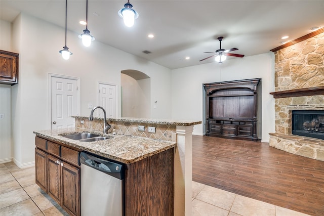 7611 Forest Ridge Trl, Sachse, TX 75048 - kitchen featuring dishwasher, open floor plan, ceiling fan, a stone fireplace, and light stone countertops