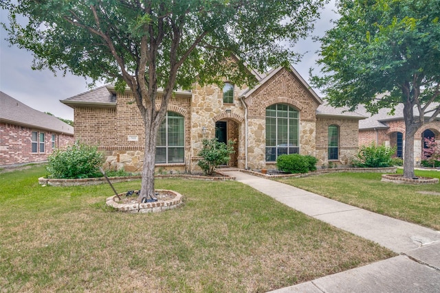7611 Forest Ridge Trl, Sachse, TX 75048 - view of front of home featuring a front lawn, stone siding, brick siding, and a shingled roof