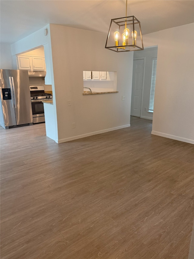 4005 Tacoma St, Irving, TX 75062 - unfurnished dining area with a chandelier and wood finished floors