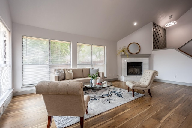 947 Aspen Dr, Desoto, TX 75115 - living room featuring vaulted ceiling, light wood-style floors, and a brick fireplace