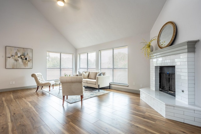 947 Aspen Dr, Desoto, TX 75115 - living room featuring high vaulted ceiling, wood finished floors, and a brick fireplace