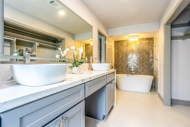 947 Aspen Dr, Desoto, TX 75115 - full bath featuring double vanity, a freestanding tub, tile patterned floors, and tile walls