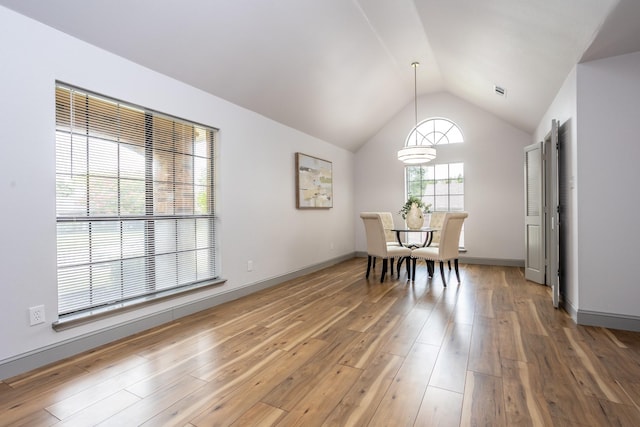 947 Aspen Dr, Desoto, TX 75115 - dining space featuring vaulted ceiling, light wood-style flooring, and a chandelier