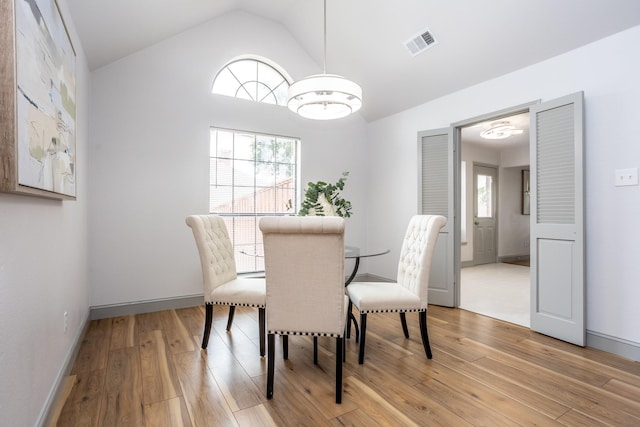 947 Aspen Dr, Desoto, TX 75115 - dining room featuring light wood-style flooring, lofted ceiling, and a chandelier
