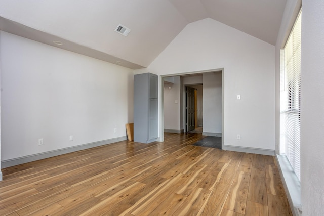 947 Aspen Dr, Desoto, TX 75115 - unfurnished bedroom with light wood-type flooring and vaulted ceiling