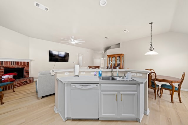 90 Elmwood Trl, Waxahachie, TX 75165 - kitchen with dishwasher, open floor plan, a center island with sink, ceiling fan, and light wood finished floors