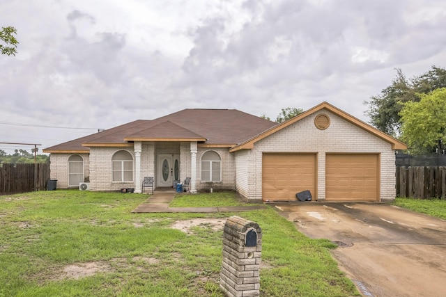 3612 Hummingbird Ave, Mcallen, TX 78504 - view of front facade with a garage, driveway, brick siding, and a shingled roof