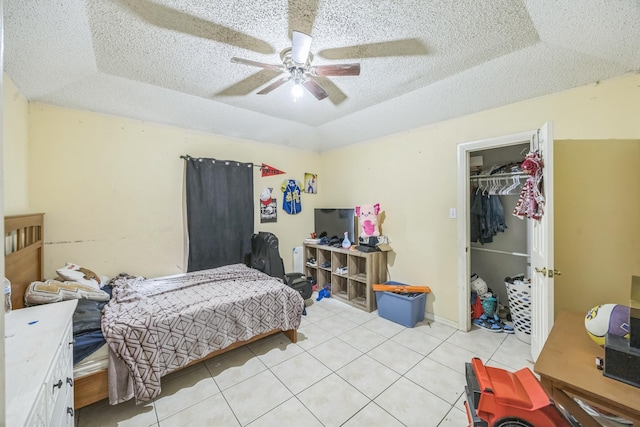 3612 Hummingbird Ave, Mcallen, TX 78504 - bedroom featuring a tray ceiling, light tile patterned floors, a textured ceiling, and ceiling fan