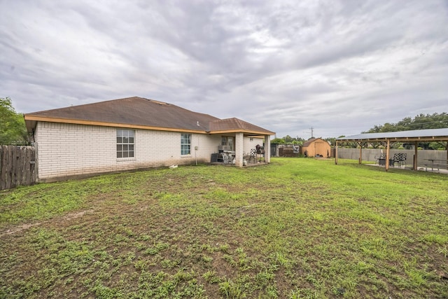 3612 Hummingbird Ave, Mcallen, TX 78504 - back of house featuring a fenced backyard, a storage unit, and a patio area