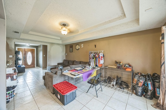 3612 Hummingbird Ave, Mcallen, TX 78504 - living room featuring a tray ceiling, tile patterned floors, and a textured ceiling