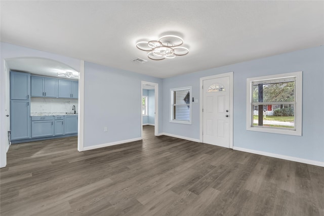 301 E Craven Ave, Lacy Lakeview, TX 76705 - foyer featuring dark wood-style flooring and arched walkways