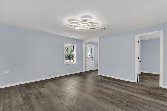 301 E Craven Ave, Lacy Lakeview, TX 76705 - spare room featuring arched walkways and dark wood finished floors