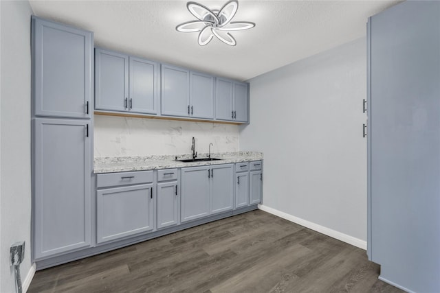 301 E Craven Ave, Lacy Lakeview, TX 76705 - kitchen with dark wood finished floors, tasteful backsplash, gray cabinets, and a textured ceiling