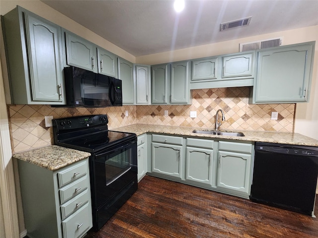1408 Bandera Dr, Arlington, TX 76018 - kitchen with black appliances, dark wood-type flooring, green cabinets, and light stone counters
