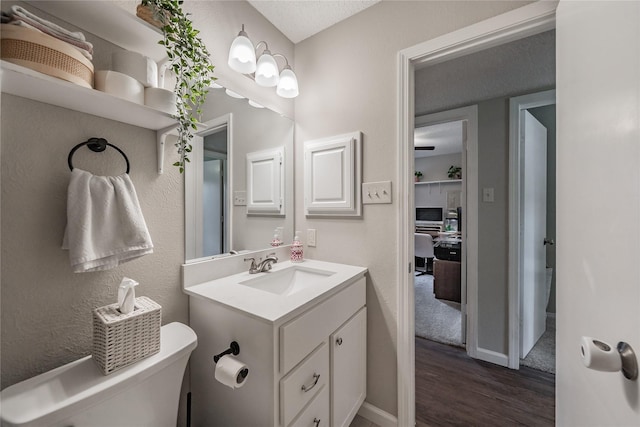 2416 Raintree Ct, Plano, TX 75074 - half bathroom with wood finished floors and vanity