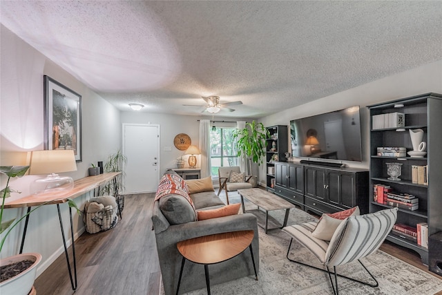 2416 Raintree Ct, Plano, TX 75074 - living area featuring a textured ceiling, wood finished floors, and a ceiling fan