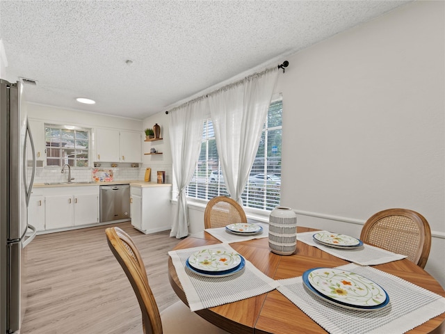 2012 Westlake Dr, Plano, TX 75075 - dining area with plenty of natural light, a textured ceiling, and light wood-style flooring