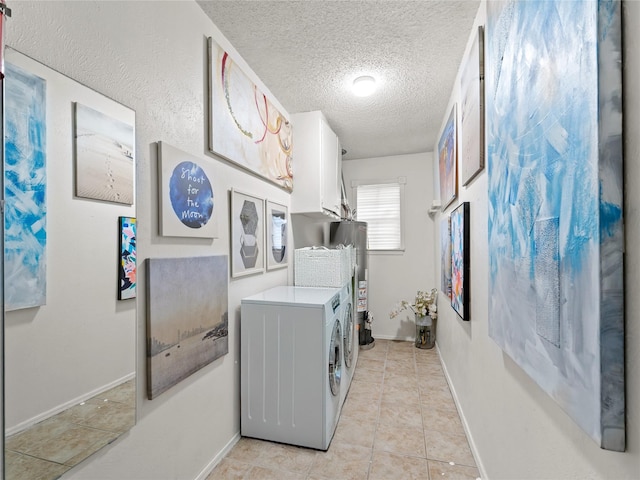 2012 Westlake Dr, Plano, TX 75075 - laundry room with a textured ceiling, independent washer and dryer, cabinet space, light tile patterned flooring, and gas water heater