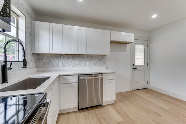 2504 Wicker Ave, Farmers Branch, TX 75234 - kitchen featuring appliances with stainless steel finishes, light wood finished floors, white cabinets, tasteful backsplash, and recessed lighting