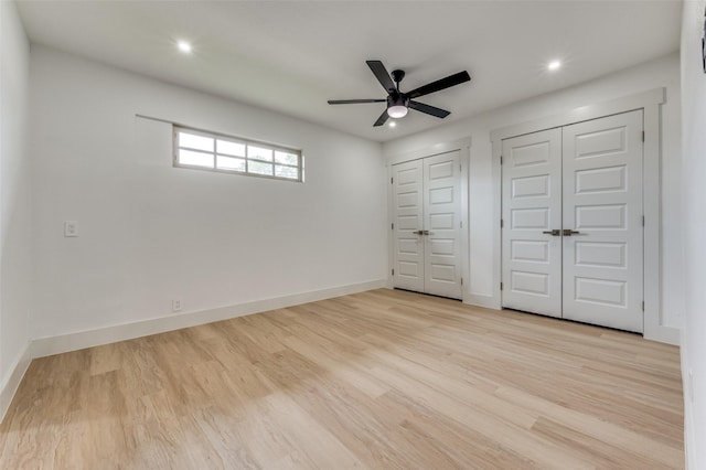 2504 Wicker Ave, Farmers Branch, TX 75234 - unfurnished bedroom with multiple closets, wood finished floors, recessed lighting, and a ceiling fan