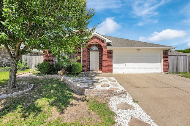 5900 Rising Meadow Dr, Arlington, TX 76018 - view of front of house featuring brick siding, a garage, and driveway