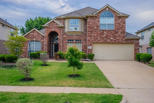 5920 Colby Dr, Plano, TX 75094 - traditional-style house featuring driveway, a garage, a front yard, and brick siding
