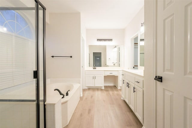 5920 Colby Dr, Plano, TX 75094 - full bathroom with vanity, a garden tub, a shower stall, and wood finished floors