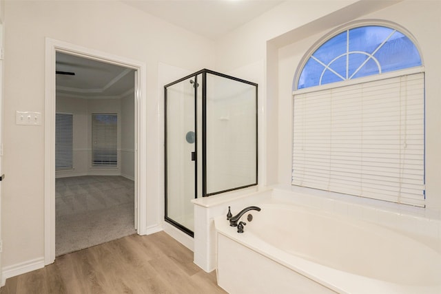 5920 Colby Dr, Plano, TX 75094 - bathroom with a bath, wood finished floors, and a shower stall