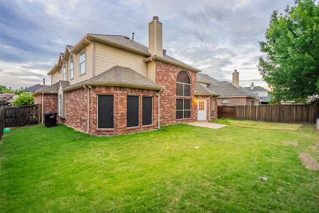 5920 Colby Dr, Plano, TX 75094 - rear view of house featuring a chimney, a fenced backyard, brick siding, and roof with shingles