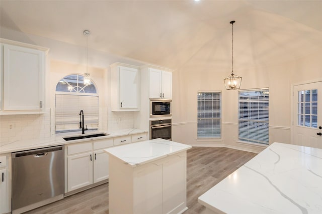 5920 Colby Dr, Plano, TX 75094 - kitchen featuring appliances with stainless steel finishes, a chandelier, light wood finished floors, tasteful backsplash, and lofted ceiling