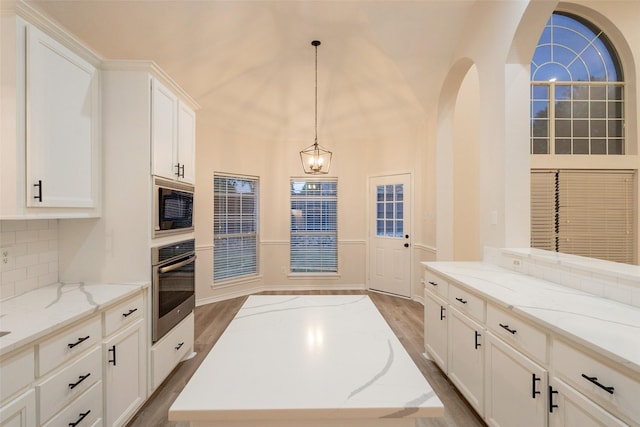 5920 Colby Dr, Plano, TX 75094 - kitchen with oven, black microwave, backsplash, white cabinetry, and wood finished floors
