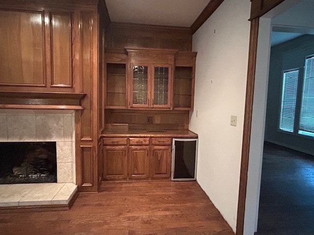6 Oak Forrest Cir, Denton, TX 76210 - bar featuring wine cooler, wood finished floors, a fireplace, and ornamental molding