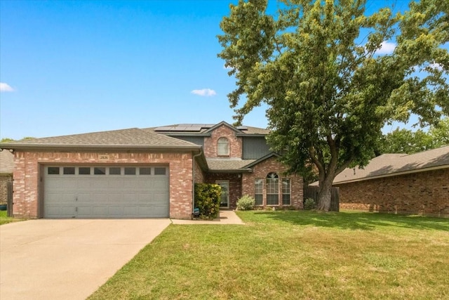 2826 Garden Oaks Pl, Grand Prairie, TX 75052 - view of front of property with an attached garage, roof mounted solar panels, brick siding, a front yard, and driveway