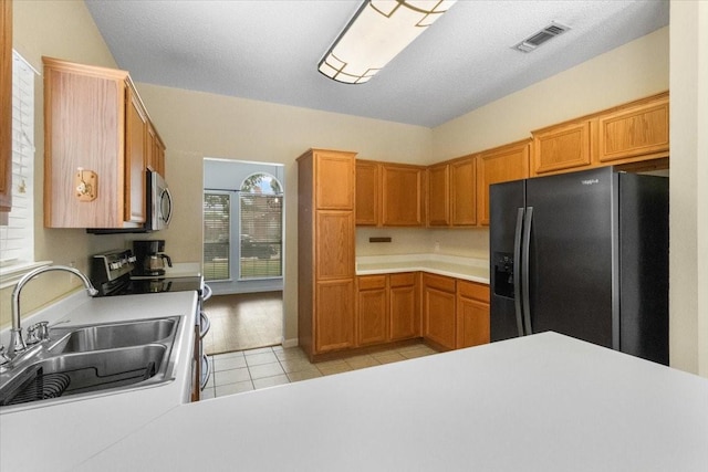 2826 Garden Oaks Pl, Grand Prairie, TX 75052 - kitchen with appliances with stainless steel finishes, light tile patterned floors, and light countertops
