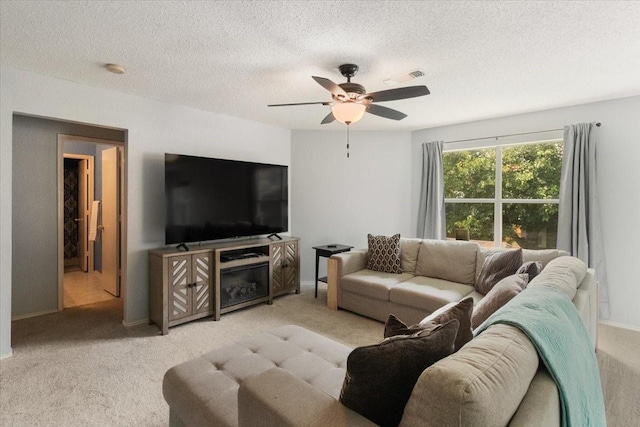 2826 Garden Oaks Pl, Grand Prairie, TX 75052 - living area featuring light colored carpet, a ceiling fan, and a textured ceiling
