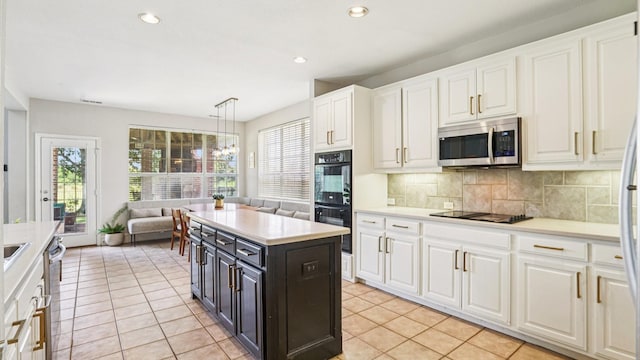 2945 Horseshoe Trl, Frisco, TX 75033 - kitchen featuring black appliances, white cabinets, light countertops, tasteful backsplash, and recessed lighting