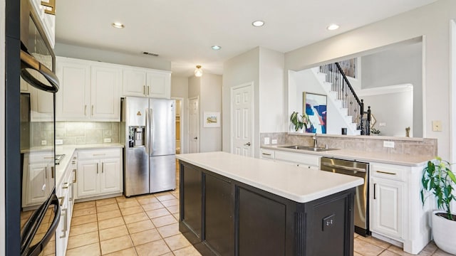 2945 Horseshoe Trl, Frisco, TX 75033 - kitchen featuring stainless steel appliances, backsplash, white cabinetry, a kitchen island, and recessed lighting