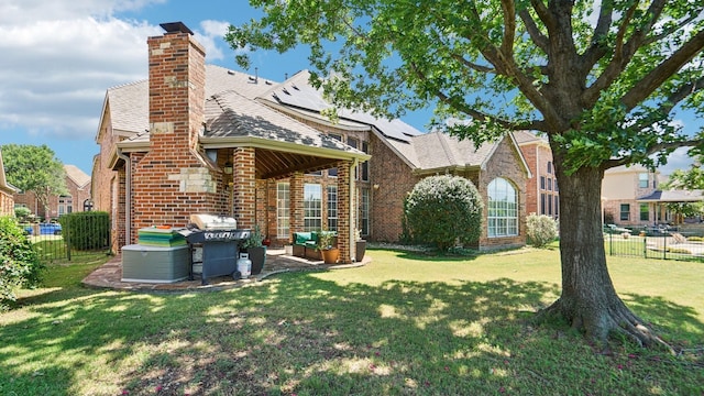 2945 Horseshoe Trl, Frisco, TX 75033 - rear view of property with brick siding, solar panels, a chimney, a shingled roof, and a patio area