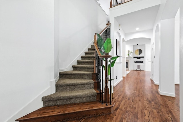 15773 Waterview Dr, Frisco, TX 75035 - stairs featuring arched walkways, wood finished floors, and recessed lighting