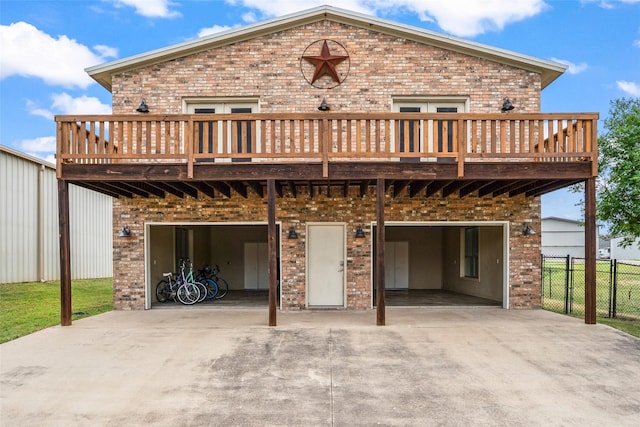 2910 Eagles Nest Ct, Midlothian, TX 76065 - rear view of property featuring a garage, brick siding, a wooden deck, and driveway