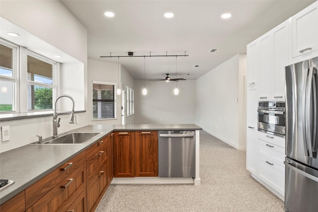 2910 Eagles Nest Ct, Midlothian, TX 76065 - kitchen with appliances with stainless steel finishes, a ceiling fan, white cabinetry, brown cabinets, and recessed lighting
