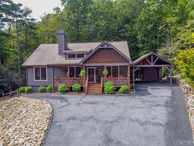 view of front of property featuring a porch and a carport