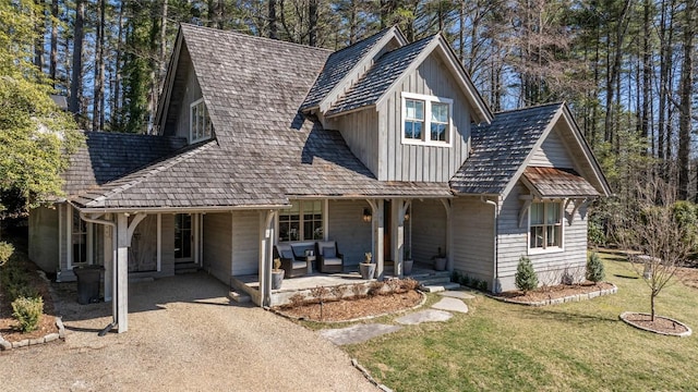 view of front of home featuring a porch, board and batten siding, and a front yard