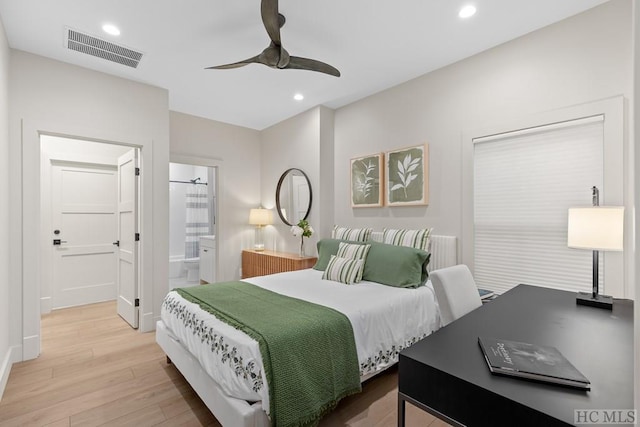 bedroom with ceiling fan, light hardwood / wood-style flooring, and connected bathroom