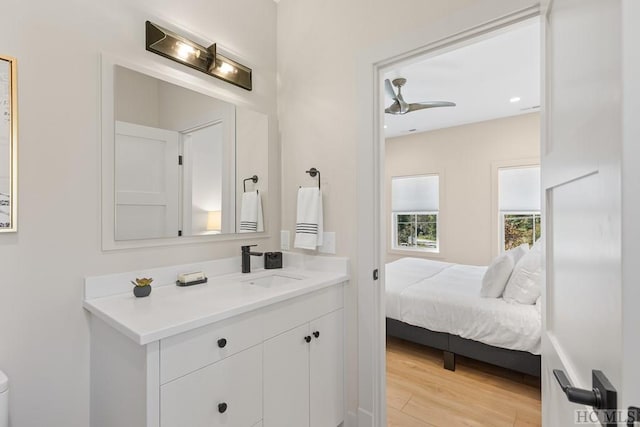 bathroom featuring ceiling fan, wood-type flooring, and vanity