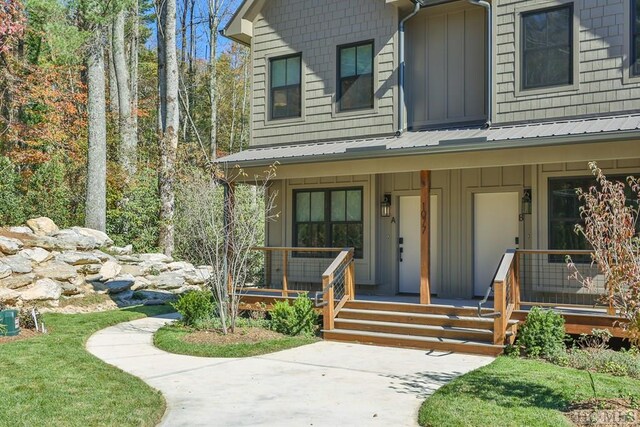 view of exterior entry with a porch