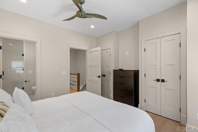 bedroom featuring light wood-type flooring, connected bathroom, and ceiling fan