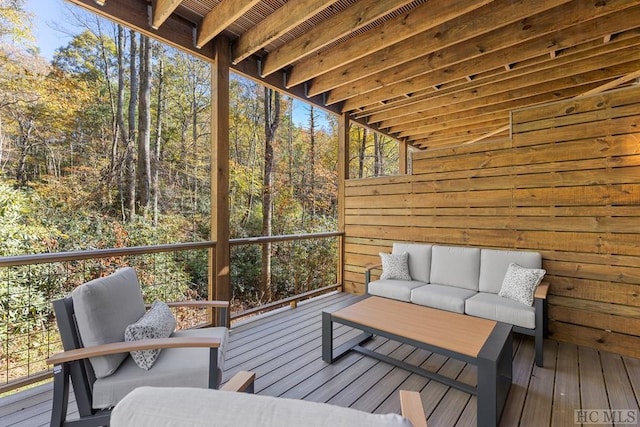 wooden terrace with an outdoor hangout area