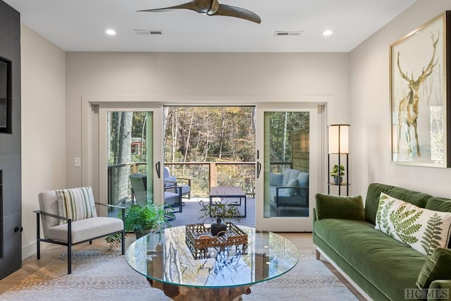 living room featuring hardwood / wood-style floors and ceiling fan